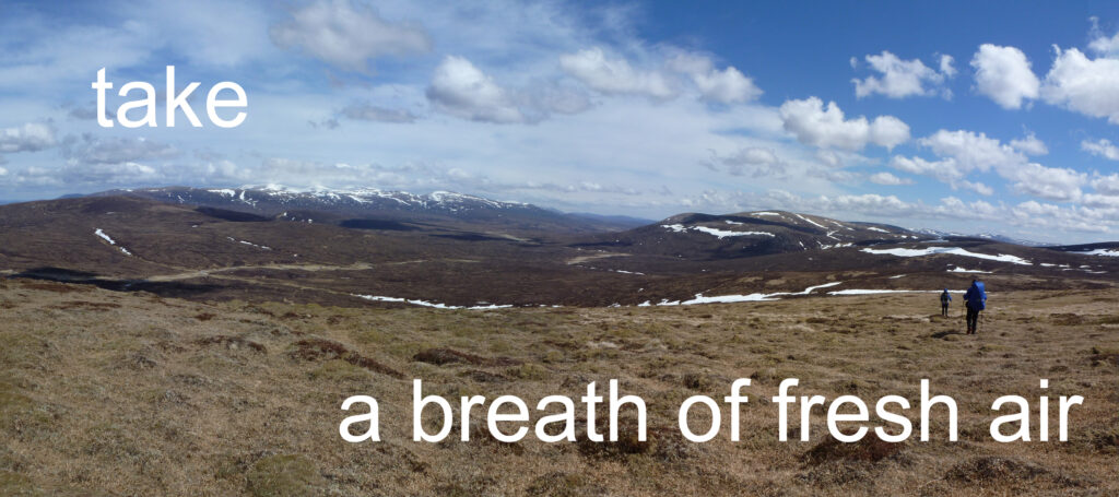 Two walkers in the Upper Feshie valley in Scottish Highlands. Text overlay reads, Take a breath of fresh air