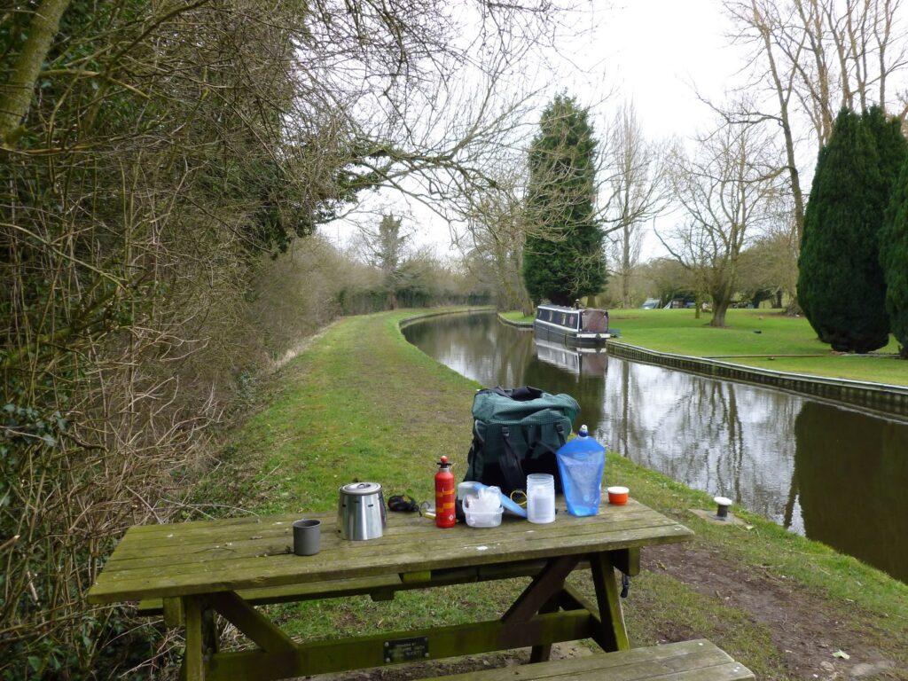 David's stove & kit on a picnic bench by the canal