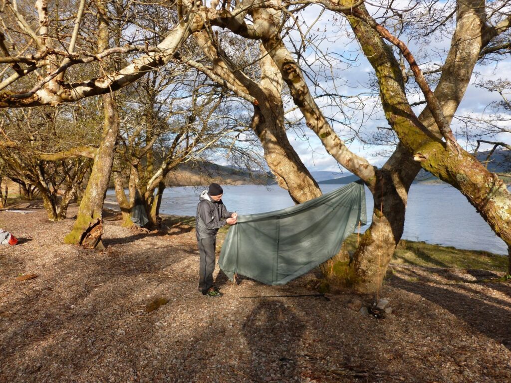 Frederick removing ticks from his tarp.