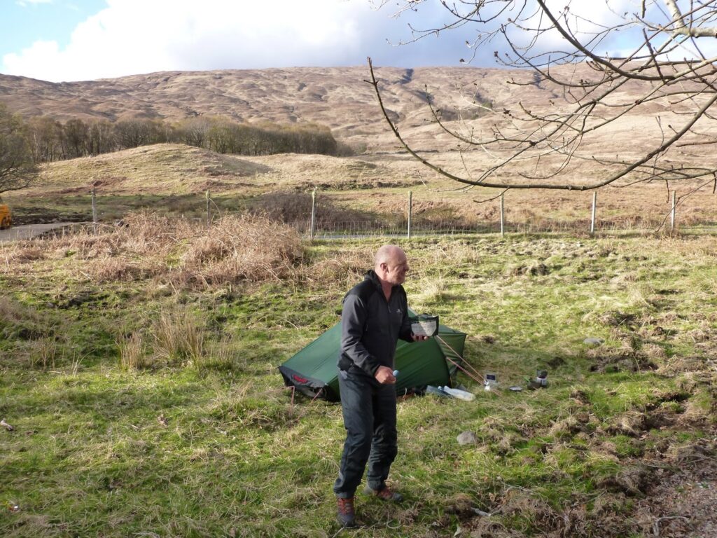 John at the camp site - perhaps with a tick tickling.