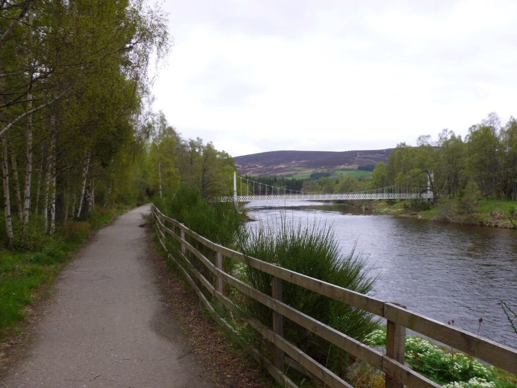 Deeside way pathe with river and the Cambus o' May suspension bridge