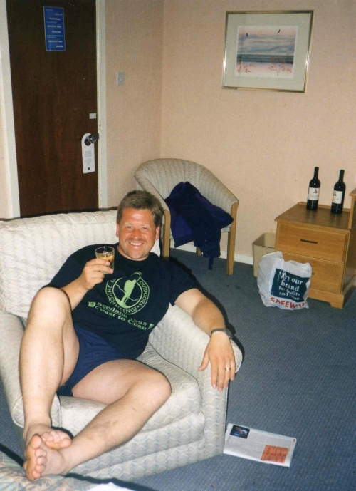 Geoff relaxes with a drink in hotel room