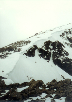 Slope down to the arête - a snow covered ridge with cornice on lee side