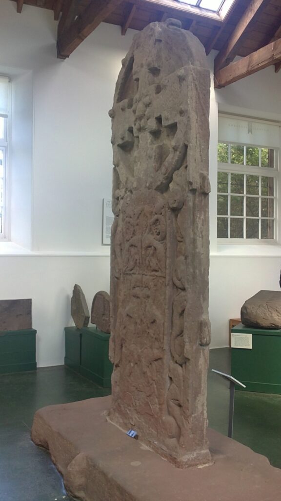 Stone in Pictish Museum showing man torn by animals