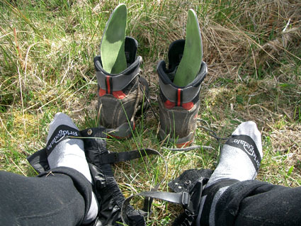 feet in liners by a pair of boots with liners removed