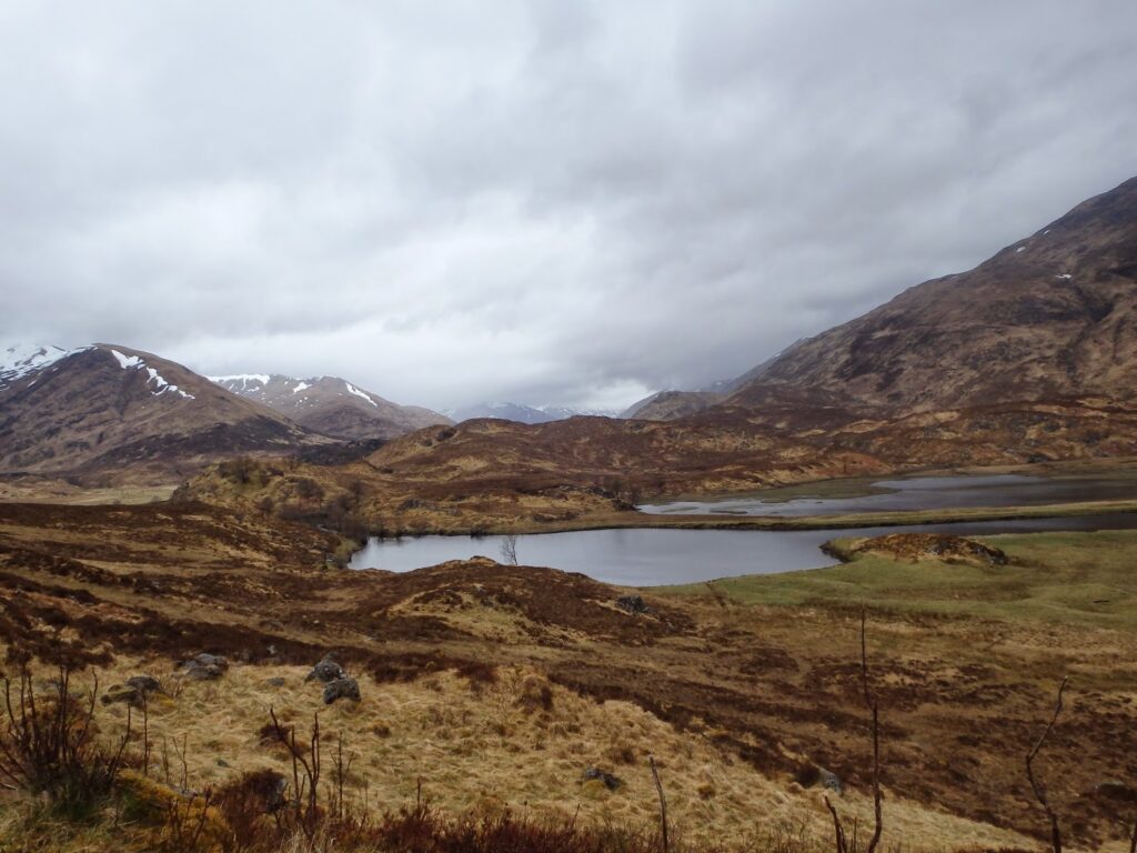 View with loch, hills and cloudy skies