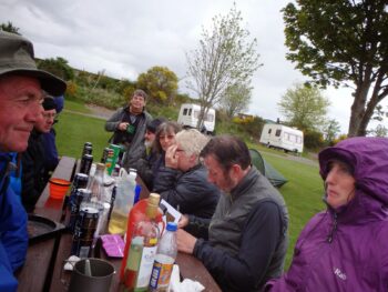 Lynsey's birthday party around a picnic table with lots of bottles