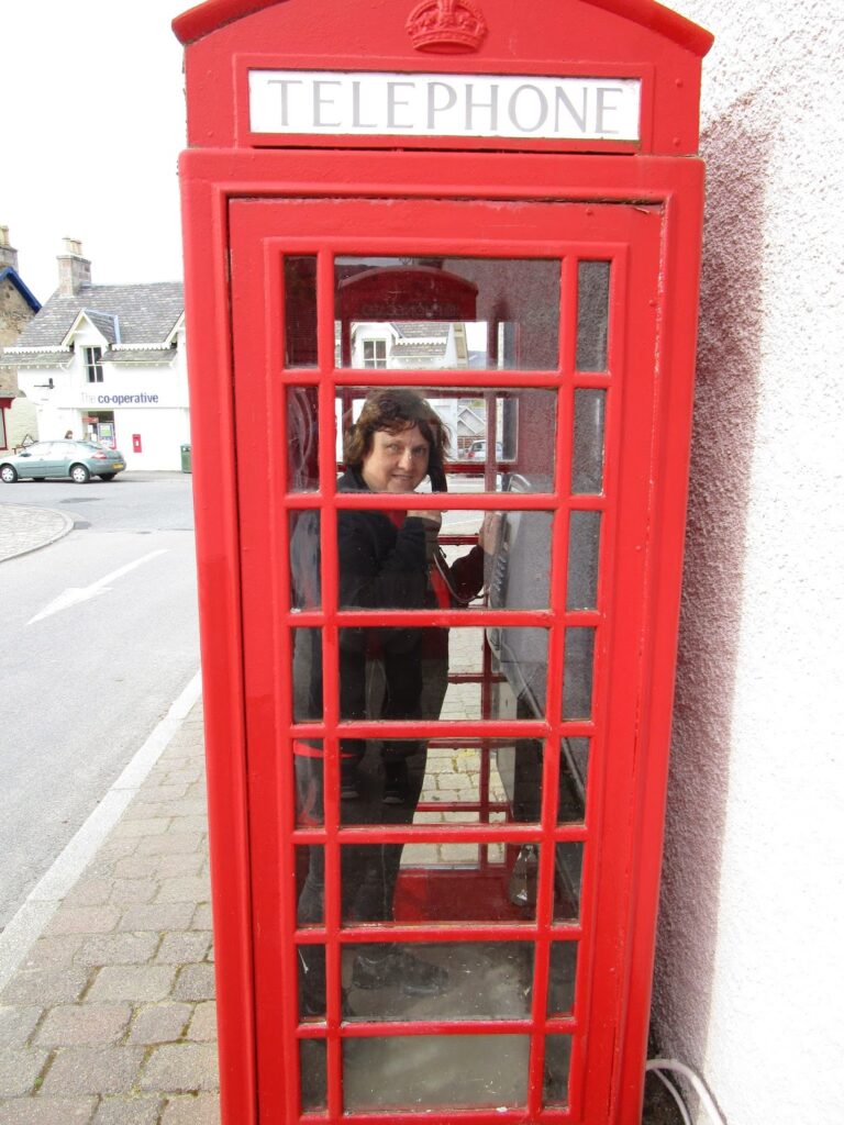 Vicky in a traditional red phone booth