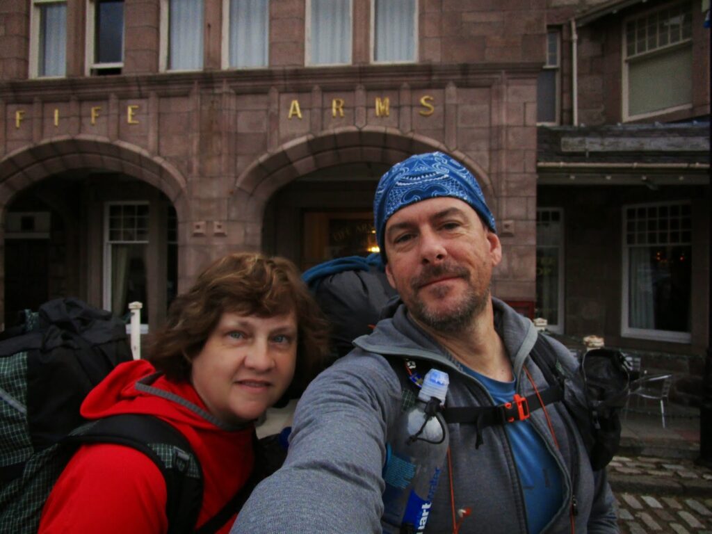 Craig & Vicky selfie outside the Fife Arms in Braemar, wearing packs and ready to set off.