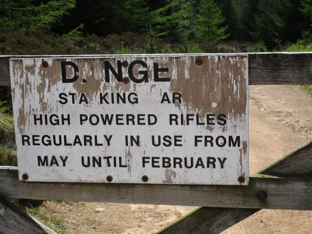 Sign warning of high powered rifles in use from May to February.