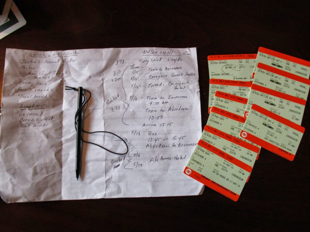 Notebook with train and bus times and reservations noted with all the train tickets alongside
