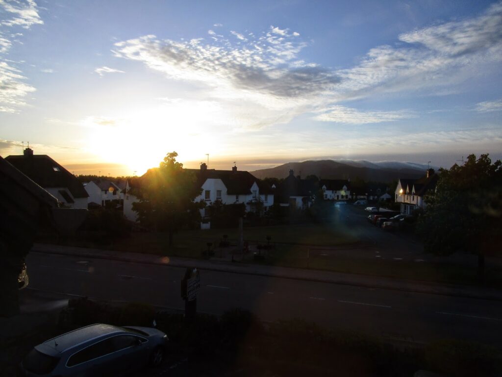 Dawn breaking over distant hills